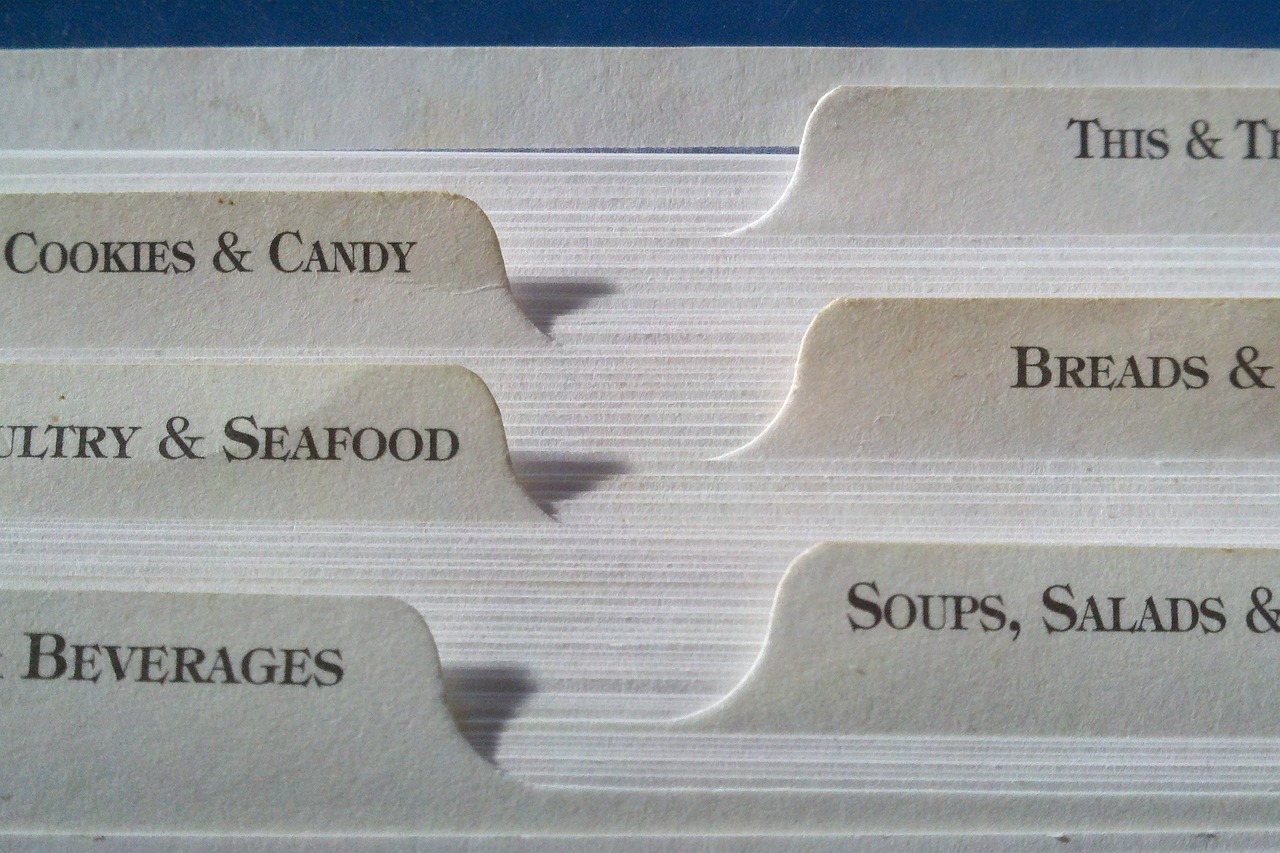 A close up view of index cards, each bookmarked with a different kind of food